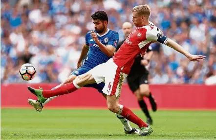  ?? — Reuters ?? Stepping up to the plate: Arsenal’s Per Mertesacke­r (right) vying for the ball with Chelsea’s Diego Costa in the English FA Cup final at Wembley on Saturday. Arsenal won 2-1.