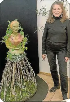  ??  ?? Artist Susan Hogan beside a figurative garden sculpture.