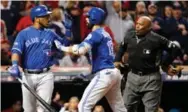  ?? CARLOS OSORIO/TORONTO STAR ?? Edwin Encarnacio­n is restrained by Jose Bautista as he argues with home plate umpire Laz Diaz late in the eighth inning.