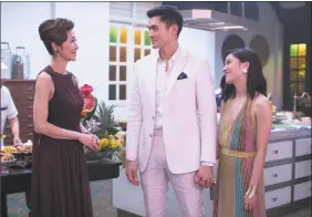 ?? Sanja Bucko / Associated Press ?? Michelle Yeoh, left, Henry Golding and Constance Wu in a scene from the film “Crazy Rich Asians.”