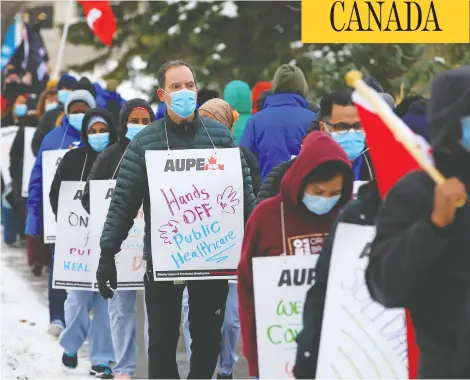  ?? GAVIN YOUNG / POSTMEDIA NEWS ?? Health-care workers angry over provincial job cuts in the health sector protest during a walkout at the Foothills Hospital in Calgary on Monday.