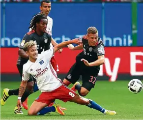  ?? — EPA ?? No, you don’t: Hamburg’s Lewis Holtby slides across to stop Bayern Munich’s Joshua Kimmich during the Bundesliga match in Hamburg on Saturday. Kimmich scored the only goal in Bayern’s victory.