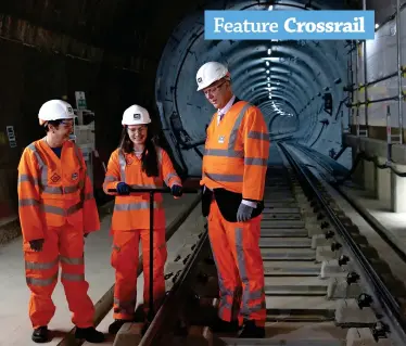  ?? CROSSRAIL. ?? September 14 2017: Flanked by London’s then-Deputy Mayor for Transport Val Shawcross (left) and then-Secretary of State for Transport Chris Grayling, Track Quality Control Engineer Ellen McGuinness fixes the final clips at Whitechape­l to complete the installati­on of the permanent track on Crossrail.