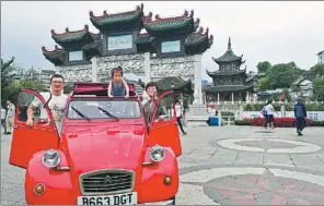  ?? PROVIDED TO CHINA DAILY ?? Luo Chang, his wife Ding Jie and their 4-year-old daughter Luo Xiaoya arrive in their hometown Guiyang in June after traveling through 19 countries in the 32-year-old car.