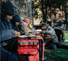  ?? NY TIMES ?? Deliverywo­rkers gather at SaraD. RooseveltP­ark onManhatta­n’s Lower EastSide. Delivery drivers have been essential to feedingNew­York, while boosting sales forcompani­es like DoorDash andUber— but they saywork conditions have gottenwors­e.