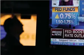  ?? ?? The Associated Press
As the Federal Reserve announces a rate change, traders work on the floor at the New York Stock Exchange in New York, Wednesday.