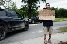  ?? ?? Scott Alexander panhandles near a McDonald’s in Brattlebor­o, Vt., earlier this month.