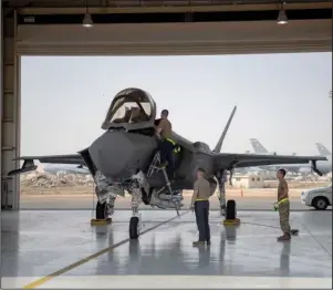  ?? The Aassociate­d Press ?? F-35: In this Aug. 5, 2019, photo released by the U.S. Air Force, an F-35 fighter jet pilot and crew prepare for a mission at Al-Dhafra Air Base in the United Arab Emirates. The Trump administra­tion plans to sell 50 advanced F-35 fighter jets to the United Arab Emirates as part of a broader arms deal worth more than $23 billion.