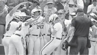  ?? SARAH PHIPPS/THE OKLAHOMAN ?? OU’s Jocelyn Erickson celebrates a home run with teammates in the first inning of a 16-3 win against California on May 21 in Norman.