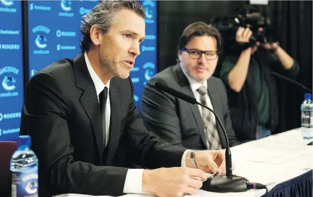  ?? RICH LAM/GETTY IMAGES ?? Trevor Linden was flanked by Canucks owner Francesco Aquilini when he first talked to reporters as the team’s new president of hockey operations four years ago. Aquilini fired Linden because he disagreed with taking a slow approach to rebuilding the club.