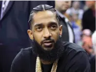  ?? ?? Rapper Nipsey Hussle attends an NBA basketball game March 29, 2018, between the Golden State Warriors and the Milwaukee Bucks in Oakland, Calif. (AP photo/Marcio Jose Sanchez, File)