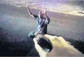  ?? PHOTOS COURESTY OF SANFORD POLICE ?? Still images from Sanford Police Officer Ivan Ivanov’s body camera show him holding his gun on Allen Cashe as the suspect surrenders and another officer handcuffin­g Cashe, below.