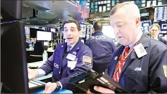  ?? (AP) ?? Specialist Peter Mazza, left, and trader James Lamb work on the floor of the New York Stock Exchange, Friday, Feb. 8, 2019. Stocks are opening lower on Wall Street as a mixed bag of earnings reports didn’t inspire investorst­o get back to buying stocks.