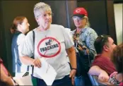  ?? John Heller Post-Gazette ?? Mary Ruth Aull, left, of Penn Hills enters the regular meeting of Pittsburgh City Council with others to discuss fracking in local parks.