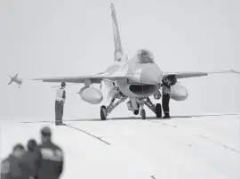  ?? ASSOCIATED PRESS ?? Technician­s inspect an Israeli Air Force F-16 jet at the Ovda airbase near Eilat, southern Israel.