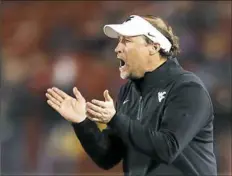  ?? Charlie Neibergall/Associated Press ?? West Virginia coach Dana Holgorsen hopes his team can keep Baylor from putting up “Xbox-type numbers.”