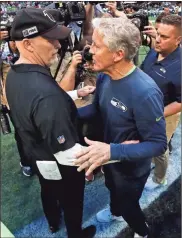  ?? AP - John Bazemore, file ?? Falcons coach Dan Quinn (left) and Seahawks coach Pete Carroll greet one another after their previous meeting, just last season, at Mercedes-Benz Stadium.