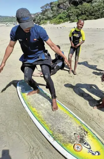  ?? Pictures: UNSTRESSED SURFSCHOOL ?? SURFS UP: Lulama Komisa, 26, of Chintsa East, was one of the first children to learn how to surf with the Unstressed Surf School. Now it is his turn to pass on his skills to the next generation of eager surfers from Chintsa village.