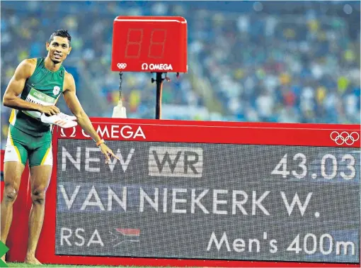  ??  ?? History boy: Wayde van Niekerk points to his 400m world record