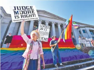  ?? ASSOCIATED PRESS PHOTOS ?? Demonstrat­ors gather during the trial of Alabama Chief Justice Roy Moore on Wednesday at the Alabama Judicial Building in Montgomery, Ala.