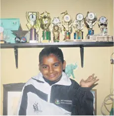  ??  ?? Richards Bay chess player - Paityn Reddy shows off her collection of chess accolades