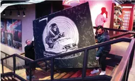  ?? Photograph: Kirsty O’Connor/PA ?? The Banksy work is moved to be displayed in the window of the Hard Rock Cafe in London.