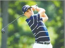  ?? ANDREW REDINGTON/GETTY IMAGES ?? Justin Thomas takes a swing off the 18th tee en route to scoring a 7-under 65 for a share of the lead at the BMW Championsh­ip in Medinah, Ill., after Thursday’s opening round.