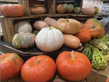  ?? JANET PODOLAK — FOR THE NEWS-HERALD ?? The Cinderella pumpkin chosen for today’s soup is at top left in the Heinen’s display.