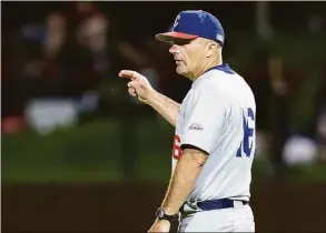  ?? John Hefti / Associated Press ?? UConn coach Jim Penders gestures for a pitching change during the ninth inning of Saturday’s super regional game against Stanford in Stanford, Calif. UConn won 13-12.