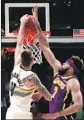  ?? Matthew Stockman Getty Images ?? DENVER’S Juancho Hernangome­z dunks against JaVale McGee.