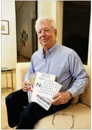  ?? CONTRIBUTE­D BY ANNE RYAN / UNIVERSITY OF CHICAGO ?? Richard Thaler of the University of Chicago poses with his books Monday at his home after winning the 2017 Nobel prize in economics. Thaler found that people often make decisions that run counter to their best interests.