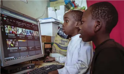  ?? Photograph: Brian Inganga/AP ?? Two boys use a computer at an internet cafe in Nairobi, Kenya.