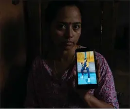  ?? UMA BISTA — THE NEW YORK TIMES ?? Shanta Thapaliya shows a photo of her brother, Sandip, who traveled to enlist as a medic in the Russian army and was killed in Bakhmut, at her home in Gorkha, Nepal this month.