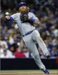  ?? ALEX GALLARDO — THE ASSOCIATED PRESS ?? Los Angeles Dodgers third baseman Justin Turner makes the throw, but cannot get San Diego Padres’ Yangervis Solarte on an infield single during the eighth inning of a baseball game in San Diego, Friday.