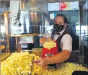  ?? GINA JOSEPH — THE MACOMB DAILY ?? Getting the concession­s ready for guests expected to arrive for the reopening of MJR Chesterfie­ld Crossing Digital Cinema 16is Macy Korn. MJR is among the theaters in Michigan reopening after seven months of being closed during the coronaviru­s pandemic.