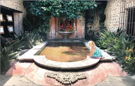  ?? Cindy Carcamo Los Angeles Times ?? THE WRITER’S daughter, Cora, plays by the fountain at Antigua’s child-friendly Porta Hotel, which offers a children’s club.