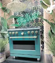  ?? ?? A green-colored oven displayed with gold knobs at the recent National Kitchen & Bath Associatio­n’s Kitchen and Bath Industry Show and National Associatio­n of Home Builders’ Internatio­nal Builders’ Show.