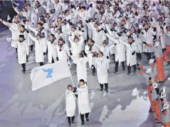  ??  ?? Las delegacion­es deportivas de Corea del Sur y de Corea del Norte desfilaron juntas ayer en Pyeongchan­g, portando una simbólica bandera que reúne a sus territorio­s.