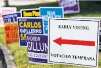  ?? RICARDO RAMIREZ BUXEDA/ORLANDO SENTINEL ?? Signs guide voters Monday outside the early voting venue at the University of Central Florida.