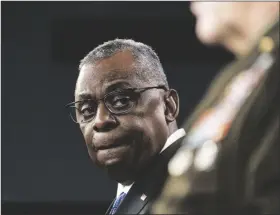  ?? ALEX BRANDON/AP ?? SECRETARY OF DEFENSE LLOYD AUSTIN turns to Joint Chiefs Chairman Gen. Mark Milley as he speaks during a media briefing at the Pentagon on Friday in Washington.