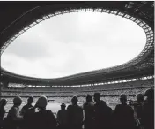  ?? ASSOCIATED PRESS ?? IN THIS July 3, 2019, file photo, media tour the New National Stadium in Tokyo. Scandals and rising costs have not deterred interest in Japan in the Tokyo Olympic. They open in a year with unpreceden­ted ticket demand.