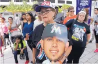 ?? LYNNE SLADKY/ASSOCIATED PRESS ?? Zoraida Martinez holds a cardboard cutout of Miami pitcher Jose Fernandez at a makeshift memorial Monday outside Marlins Park. Fernandez was killed in a boating accident Sunday.