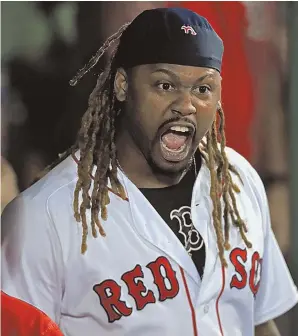  ?? STAFF PHOTO BY MATT STONE ?? LET 'EM HEAR IT: Hanley Ramirez screams out at a television camera inside the dugout after his sixth-inning homer last night at Fenway Park.