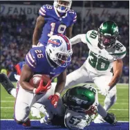  ?? Joshua Bessex / Associated Press ?? Bills running back Devin Singletary scores a touchdown during the second half against the Jets on Sunday.