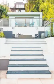  ?? Photograph­y by Olga Soboleva / Vanguard Properties ?? Above left: The open kitchen features Caesarston­e counters with waterfall edges. Above right: The terraced landscape has multiple patios and a detached studio. Below left: The family room has built-in speakers and wide-plank hardwood flooring. Below...