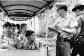  ??  ?? A San Antonio police officer takes statements after the Brackenrid­ge Eagle Line’s “Old No. 99” train was robbed at gunpoint by two masked men July 18, 1970.
