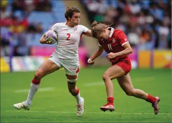  ?? ?? The Associated Press
England’s Abbie Brown, left, is tackled by Canada’s Piper Logan in this file photo from late last month.