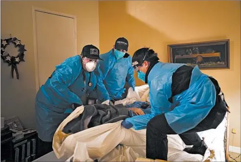  ?? JAE C. HONG/AP ?? Emergency medical workers Jacob Magoon, from left, Joshua Hammond and Thomas Hoang lift a patient onto a gurney Jan. 9 in Placentia, California.