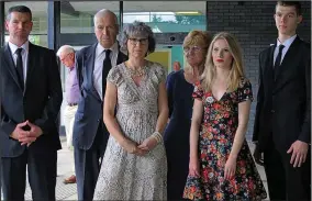  ??  ?? Grief: Ella’s mother Fiona, centre, with family members yesterday