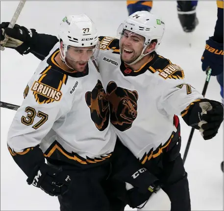  ?? MATT STONE — BOSTON HERALD ?? Jake DeBrusk, right, of the Bruins celebrates Patrice Bergeron’s game-winning goal during a 3-1 win over the St. Louis Blues on Monday night in Boston.